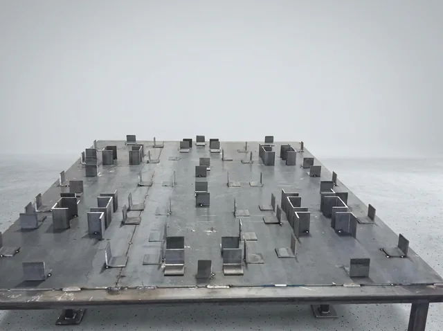 Fabrication Fixtures — Fixtures arranged across a fabrication table.
