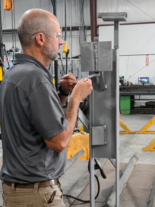 A Sapper team member working on a steel assembly in Piketon