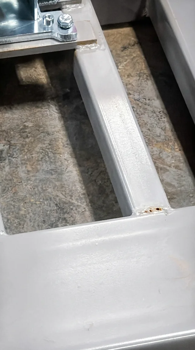 Welded Frame Detail — Close-up of a welded corner on a metal frame.